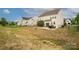 Expansive backyard with patio, outdoor dining set, and black metal fence at 9159 Marasol Ln, Concord, NC 28027