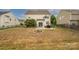 Large backyard featuring a patio, fire pit, and black metal fencing at 9159 Marasol Ln, Concord, NC 28027