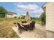 Backyard patio with umbrella table, chairs, and grill offers outdoor living space at 9159 Marasol Ln, Concord, NC 28027