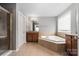 Bathroom with a soaking tub, tiled floors, and a glass-enclosed shower at 9159 Marasol Ln, Concord, NC 28027