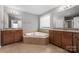 Bathroom with a soaking tub, dual sinks, and tiled floors at 9159 Marasol Ln, Concord, NC 28027