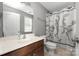 Bathroom showcasing a vanity, toilet, mirror and shower with sports-themed shower curtain at 9159 Marasol Ln, Concord, NC 28027