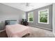 Bright bedroom with a large window, desk, and neutral decor at 9159 Marasol Ln, Concord, NC 28027