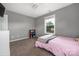 This bedroom features neutral walls, carpet, and a window for natural light at 9159 Marasol Ln, Concord, NC 28027
