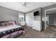 Bedroom with a large window, neutral decor, and closet at 9159 Marasol Ln, Concord, NC 28027