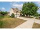 Two-story home featuring an attached two-car garage with basketball hoop and well-manicured lawn at 9159 Marasol Ln, Concord, NC 28027