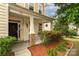 Charming front porch with brick accents, hanging flower baskets, and well-maintained landscaping welcomes you home at 9159 Marasol Ln, Concord, NC 28027