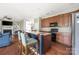 Spacious open concept kitchen with granite countertops, breakfast bar, stainless steel appliances, and eat-in area at 9159 Marasol Ln, Concord, NC 28027