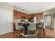 Open concept kitchen with a breakfast bar seating area, stainless steel appliances, and wooden cabinetry at 9159 Marasol Ln, Concord, NC 28027