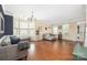 Open living area with hardwood floors, neutral walls, large windows, and a bay window at 9159 Marasol Ln, Concord, NC 28027