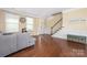 Bright living room with hardwood floors, wainscoting, and a staircase with white railings at 9159 Marasol Ln, Concord, NC 28027