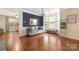 Elegant living area featuring hardwood floors, bay window, chandelier, and sophisticated decor at 9159 Marasol Ln, Concord, NC 28027