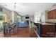Open concept living room adjacent to dining and kitchen areas, featuring a fireplace and large windows at 9159 Marasol Ln, Concord, NC 28027