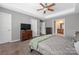 Spacious main bedroom features a tray ceiling, large window, and neutral decor at 9159 Marasol Ln, Concord, NC 28027