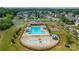 Aerial view of the community pool, splash pad, playground, and surrounding homes at 9159 Marasol Ln, Concord, NC 28027