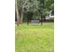 Backyard featuring a porch swing hung from a frame on a grassy lawn with mature trees at 925 Grace Ave, Lancaster, SC 29720