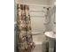 Bright bathroom featuring a shower/tub combination with decorative floral curtains and a pedestal sink at 925 Grace Ave, Lancaster, SC 29720