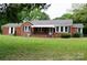 Charming brick home with a well-maintained lawn and classic black shutters at 925 Grace Ave, Lancaster, SC 29720