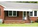 Close-up of the front porch featuring a white awning, brick detail, and security system at 925 Grace Ave, Lancaster, SC 29720