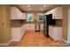 Bright kitchen with white cabinets, stainless steel appliances, and hardwood floors at 925 Grace Ave, Lancaster, SC 29720