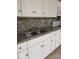 Bright kitchen features white cabinets, a double sink, and a gray countertop at 925 Grace Ave, Lancaster, SC 29720