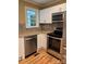 Updated kitchen features stainless steel appliances, sleek cabinets, and hardwood floors at 925 Grace Ave, Lancaster, SC 29720