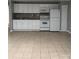Open kitchen featuring white cabinets, a range, and tiled flooring at 925 Grace Ave, Lancaster, SC 29720