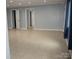 Open living space with neutral tile flooring and a view of multiple doorways at 925 Grace Ave, Lancaster, SC 29720