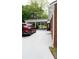 View of the parking area and carport with a red vehicle parked on the white lot at 925 Grace Ave, Lancaster, SC 29720