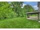 Expansive backyard featuring lush green grass and a covered patio perfect for outdoor entertaining at 9321 Bradstreet Commons Way, Charlotte, NC 28215