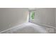 A bright bedroom with neutral walls, plush carpeting, and a window with natural light at 9321 Bradstreet Commons Way, Charlotte, NC 28215
