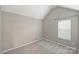 A cozy bedroom featuring neutral walls, carpet floors, and a window with natural light at 9321 Bradstreet Commons Way, Charlotte, NC 28215