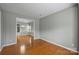 Neutral dining room featuring hardwood floors, elegant chandelier, and a view into the backyard at 9321 Bradstreet Commons Way, Charlotte, NC 28215