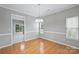 Bright dining room with hardwood floors, chair rail, chandelier and sliders to the back at 9321 Bradstreet Commons Way, Charlotte, NC 28215