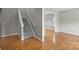 Inviting entryway with hardwood floors and a staircase, transitioning into a brightly lit living area at 9321 Bradstreet Commons Way, Charlotte, NC 28215