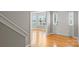 Bright foyer featuring hardwood floors, a white front door, and large windows with backyard views at 9321 Bradstreet Commons Way, Charlotte, NC 28215
