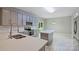 Contemporary kitchen featuring gray cabinets, stainless steel appliances, and a center island with quartz countertop at 9321 Bradstreet Commons Way, Charlotte, NC 28215