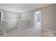 Landing at the top of stairs with neutral walls and carpet, leading into a bedroom at 9321 Bradstreet Commons Way, Charlotte, NC 28215