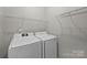 Well-lit laundry room with a washer, dryer, and wire shelving for storage at 9321 Bradstreet Commons Way, Charlotte, NC 28215
