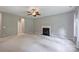 Spacious living room features a ceiling fan and a cozy fireplace at 9321 Bradstreet Commons Way, Charlotte, NC 28215
