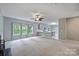 Open-concept living room features natural light and seamless flow into the modern kitchen at 9321 Bradstreet Commons Way, Charlotte, NC 28215