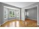 Comfortable living room showcasing hardwood floors, neutral walls, and a bay window for natural light at 9321 Bradstreet Commons Way, Charlotte, NC 28215