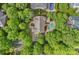 Aerial view showcasing a home with a pool nestled in a lush, green neighborhood at 9624 Barnburgh Ln, Huntersville, NC 28078