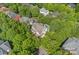 Stunning aerial view of a private home with a backyard pool surrounded by lush greenery and mature trees at 9624 Barnburgh Ln, Huntersville, NC 28078