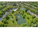 Aerial view of community amenities including tennis courts, a pool, a clubhouse, and a scenic pond at 9624 Barnburgh Ln, Huntersville, NC 28078