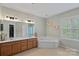 Bathroom with double vanity, corner tub, and tile flooring, providing a relaxing retreat at 9624 Barnburgh Ln, Huntersville, NC 28078