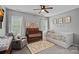 Bright Bedroom with crib, daybed, patterned rug, and ample natural light, creating a welcoming space at 9624 Barnburgh Ln, Huntersville, NC 28078
