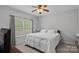 Simple bedroom with a large window offering natural light and a comfy queen-size bed at 9624 Barnburgh Ln, Huntersville, NC 28078