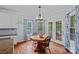 Cozy breakfast nook features hardwood floors, blue accent walls, and natural light from the exterior double doors at 9624 Barnburgh Ln, Huntersville, NC 28078