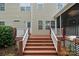 Wooden deck with stairs, white railings, and landscaped surroundings offering outdoor living space at 9624 Barnburgh Ln, Huntersville, NC 28078